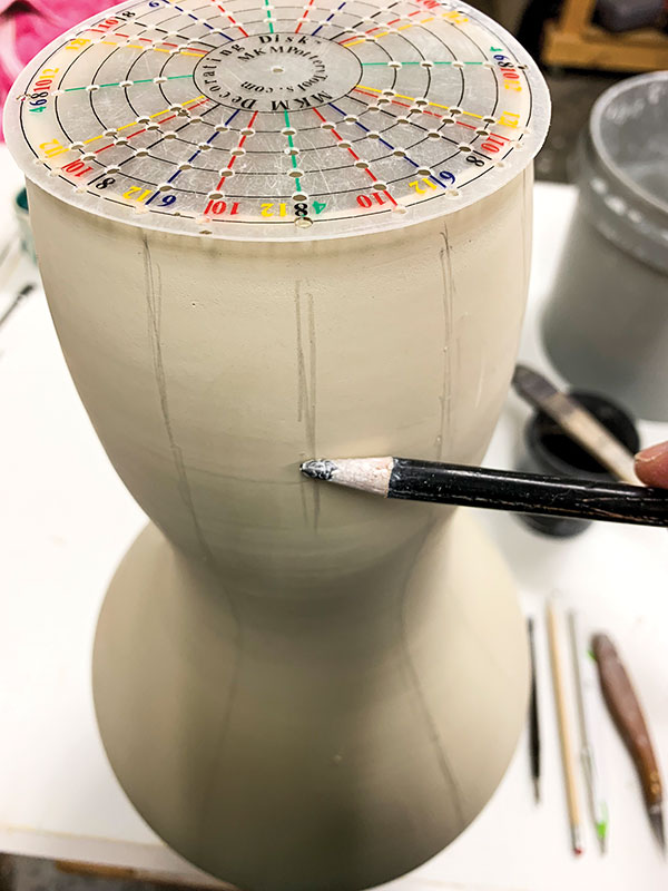 3 Divide the vase into equal sections using an MKM Decorating Disk and a dull pencil.