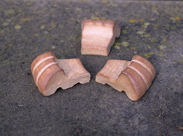 6 Three fired stoneware pot paws, each 1½ in. (4 cm) in length, ready to be placed under a pot.