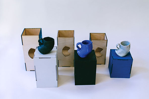 5 Dominick Vanderlip’s slip-cast cups, porcelain, fired to cone 9 in an electric kiln. Nick Ryan’s packaging, laser-cut 1/8-inch plywood, paint. 