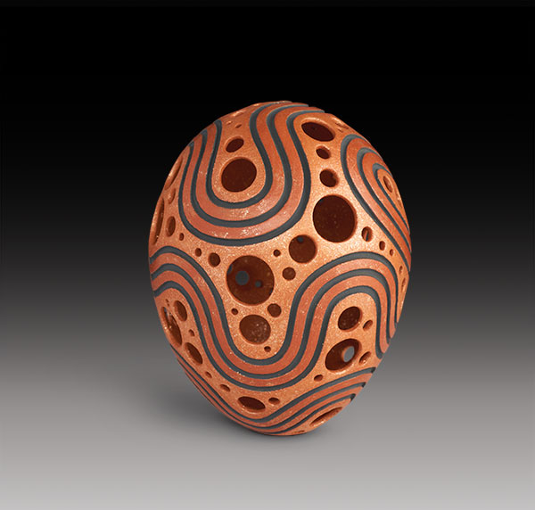 8 Hubert Candelario (San Felipe), holey pot with carved curved lines, 7 in. (18 cm) in height, orange micaceous clay.