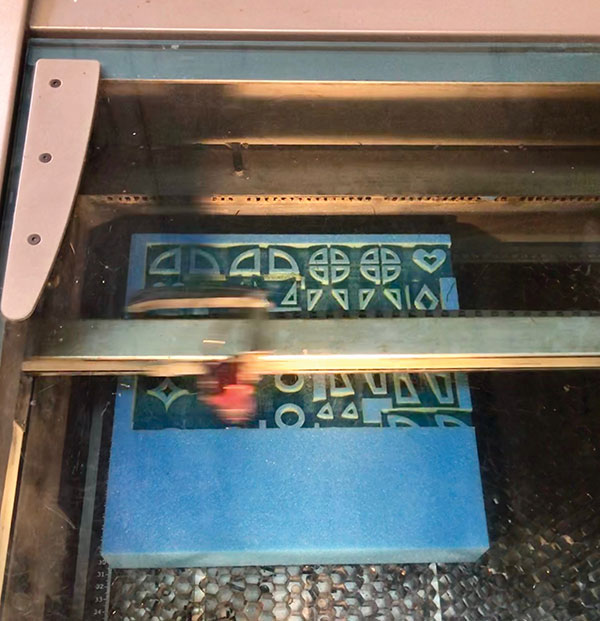1 The laser cutter in action cutting a 12×12-inch block of sponge. Prior to cutting you will determine the best power and speed of the laser. Always test and determine settings for each machine before cutting. e