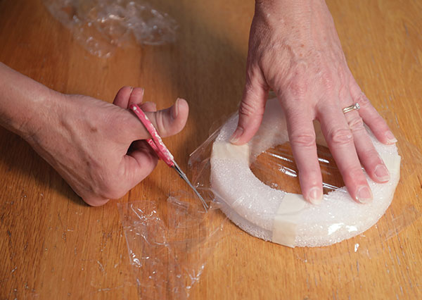 1 Stack the rings and tape them together, then cover them in plastic wrap.