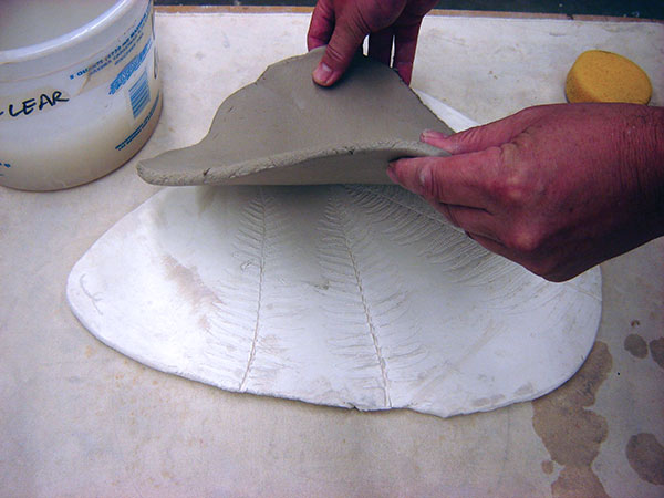 4 Press clay into bisque molds pre-made from plants and wildflowers.