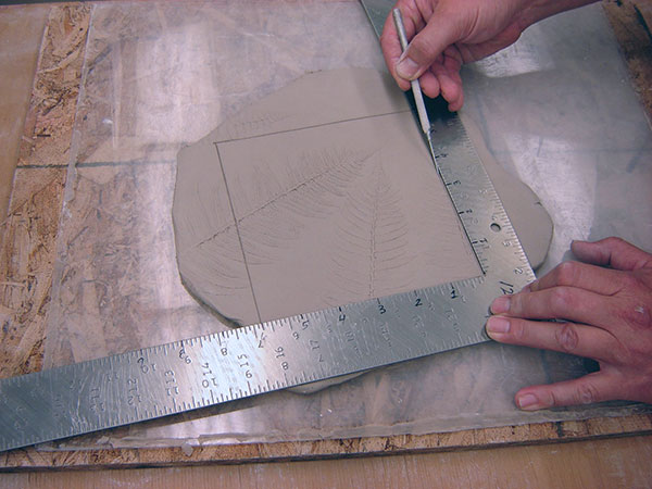 5 Place the slab facing up on a piece of Plexiglas. Measure and cut a square tile.