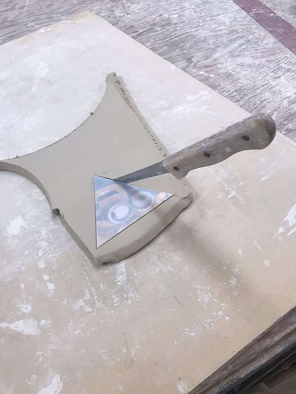 3 Use a pre-made plastic template to cut out a shaped slab for the bowl’s foot. 