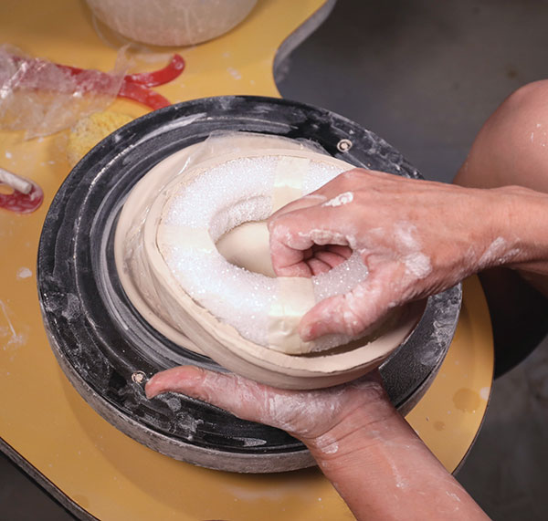 8 Turn the soft leather-hard clay dome over and remove the mold. Place the dome back on the plastic and reshape it.