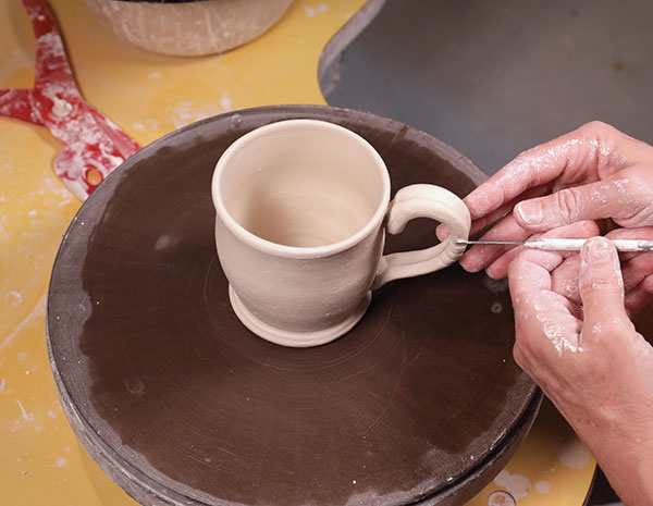 14 When the cup is stiff leather hard, score, add slip, and attach a handle. 