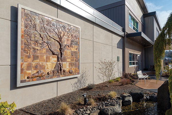 1 The Planetree mural installed outside of the radiation therapy chamber in the CMH-OHSU Knight Cancer Collaborative in Astoria, Oregon. Planetree mural, 10 ft. 8 in. (3.3 m) in height, anagama-fired stoneware, sculpted slab tiles, 5-day firing to cone 12, 2017. Photo: Justin Grafton. 