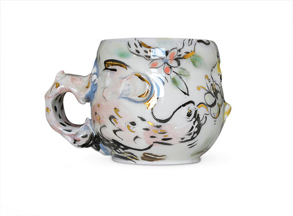 1 Emilie Bouvet-Boisclair’s Parrot and Butterfly Mug, 5 in. (13 cm) in width, porcelain, colored clay, underglaze, glaze, fired to cone 6 in oxidation, 22k gold luster, 2019.