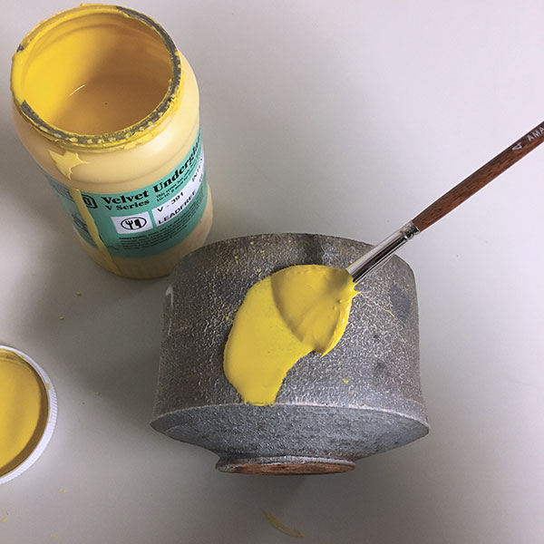 2 For this pot, I applied a thick yellow underglaze to the surface in a painterly approach.