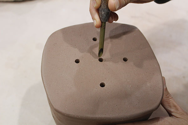 5 Create drainage holes in the bottom of the pot with a teapot hole cutter.