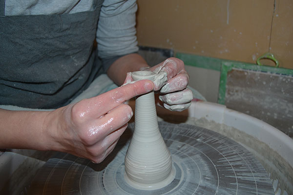 6 With 1 pound of clay, throw a tall cylinder, then collar in the neck of the pestle.