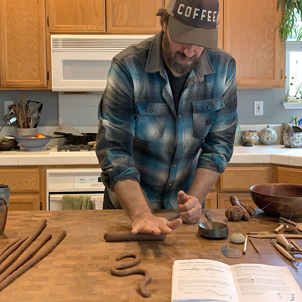 Forrest demonstrating how to roll coils.
