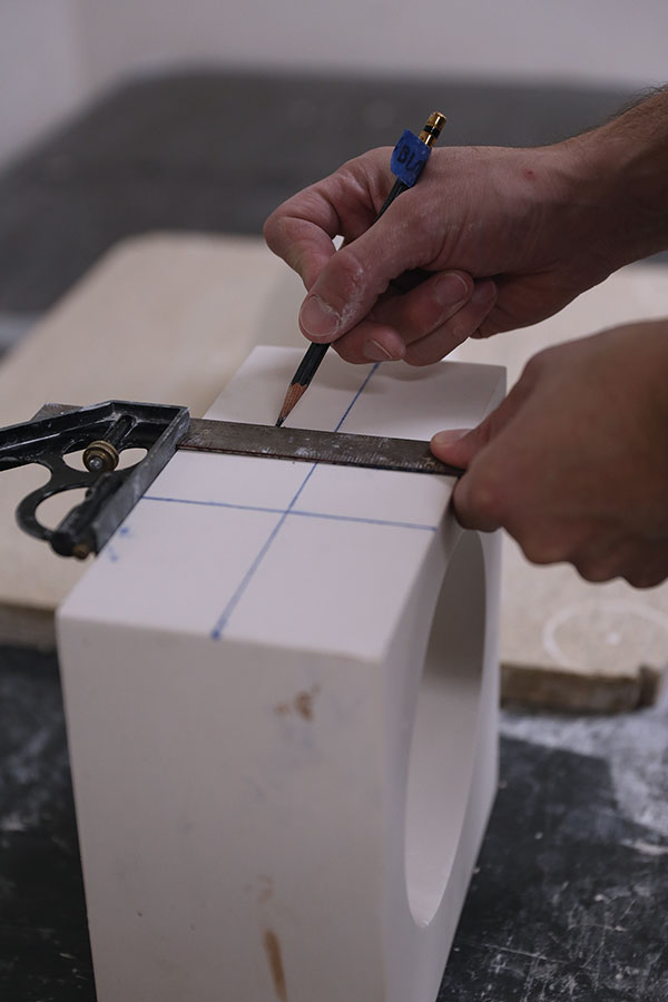 2 Map out and mark the cutting paths with a T square and pencil in preparation for cutting with the band saw.