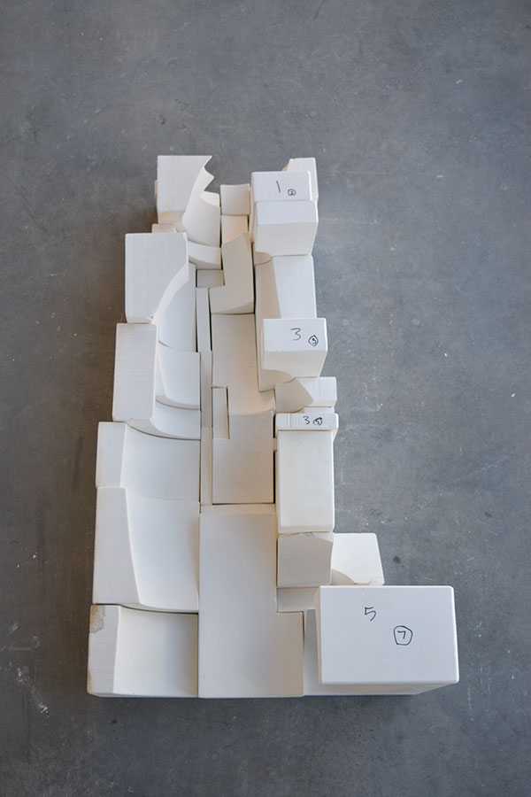 4 A cutaway view of half of a stacked assembly of mold sections to show how a rough construction of the mold stack is done to assess the form, make revisions if necessary, and to troubleshoot any potential problem areas susceptible to heavy leakage from the liner slip during casting.