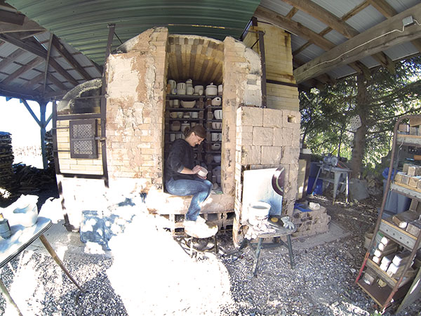 Julie Crosby at her studio loading the kiln. Photo: Marilyn Rivchin.