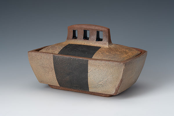 Box, 7 in. (18 cm) in length, handbuilt cone-3 earthenware, terra sigillata, black stain, wood/soda fired. Photo: Ann Cady.