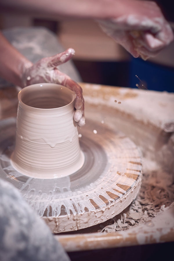 3 Jo Davies throwing at her wheel making a Speak Vase. This is the halfway point before the form is closed to create the body of the vase.