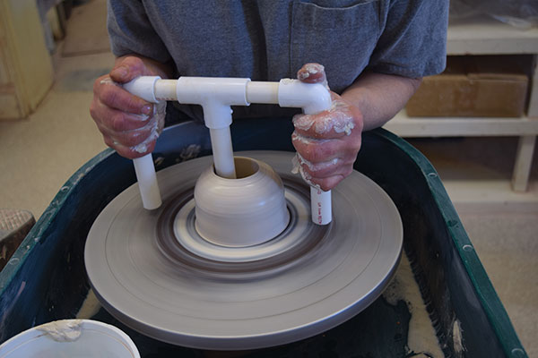 1 Open your centered ball of clay with a ball opener to create a 3/8-inch-thick floor.