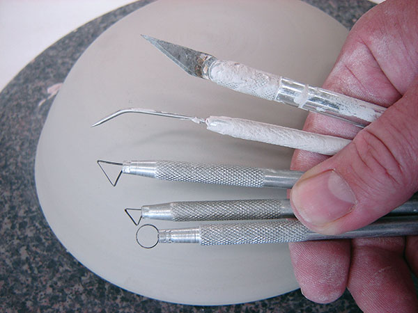2 Carving tools including an X-Acto knife, bent needle tool, and ribbon tools.