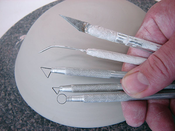 2 Carving tools including an X-Acto knife, bent needle tool, and ribbon tools. 