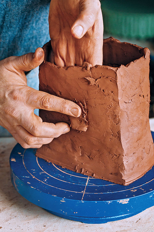 3 Place a small amount of scored soft clay into the space you’ve opened up and spread over the original crack.
