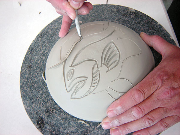 4 Carve the leather-hard dome. The clay ribbons should easily fall away.