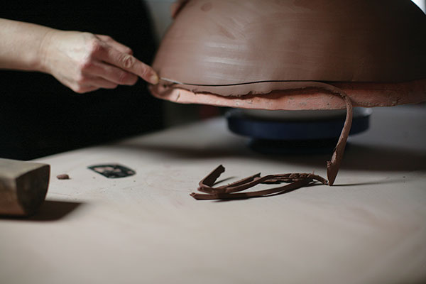 5 After the slab has set up to soft leather hard, trim the edge with a sharp knife. 