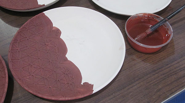 10 After bisque firing, apply a red-iron-oxide wash over the slip-trailed pattern. 