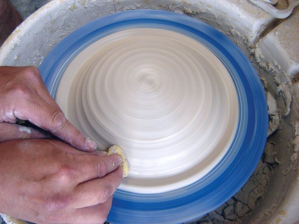 10 With the wheel spinning, compress and smooth the clay onto the dome. 