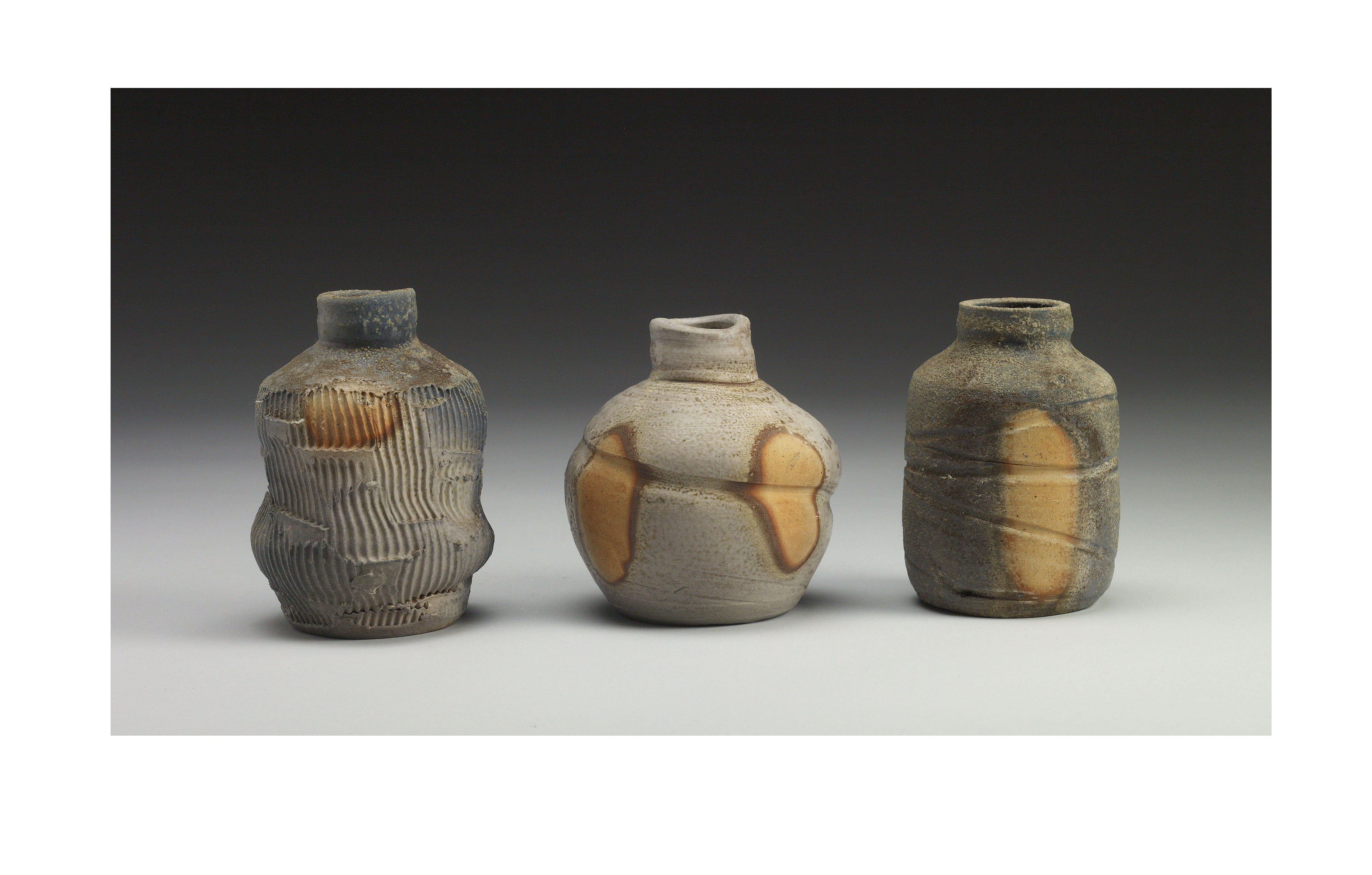 Meg Beaudoin, Mini Bottle Set, to 4.25 in. (11 cm) in height, stoneware, wadding, natural-ash glaze, fired for 7 days to cone 10 in an anagama wood kiln, 2018. www.megbeaudoinceramics.com
