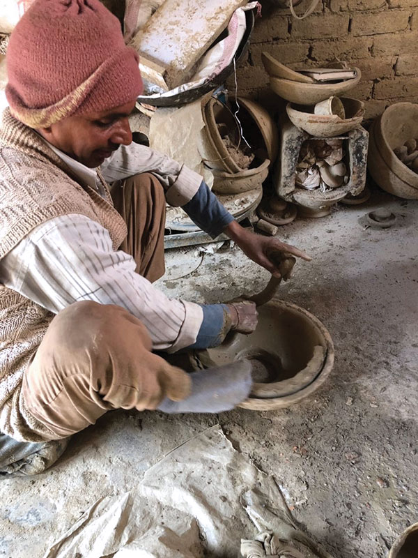 6 Attaching a coil to the base of the top section of the jar in preparation for joining the two sections.