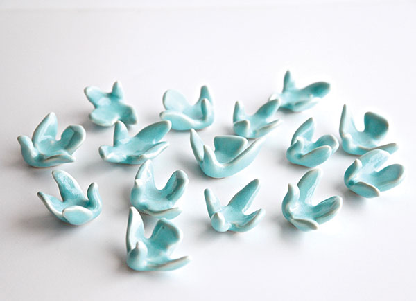 3 Blue Birds of Hope, 2½ in. (6 cm) in length each, porcelain, copper glaze, high fired in oxidation, 2020. Photo: Clara Florin.