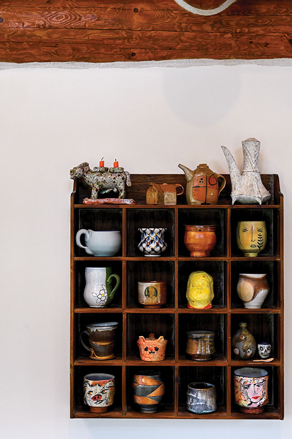 7 Gridded shelf unit with 5 × 5-inch squares featuring favorites including (top row, left to right): George McCauley’s candle holder, Maggy Rozycki Hiltner, unknown maker, and Candice Methe. Cups below (left to right): Alleghany Meadows, Sean O’Connell, Ruggles and Rankin, Matt Metz, Ben Carter, Dan Anderson, Kensuke Yamada, Simon Levin, Matt Long, Ella Hiltner, David Hiltner, bottle by Shoko Teruyama, spoon by Shalene Valenzulea, small cup by Michael Corney, Ron Meyers, Jeff Oestreich, Perry Haas, and George McCauley. All photos: Neil Carlson.