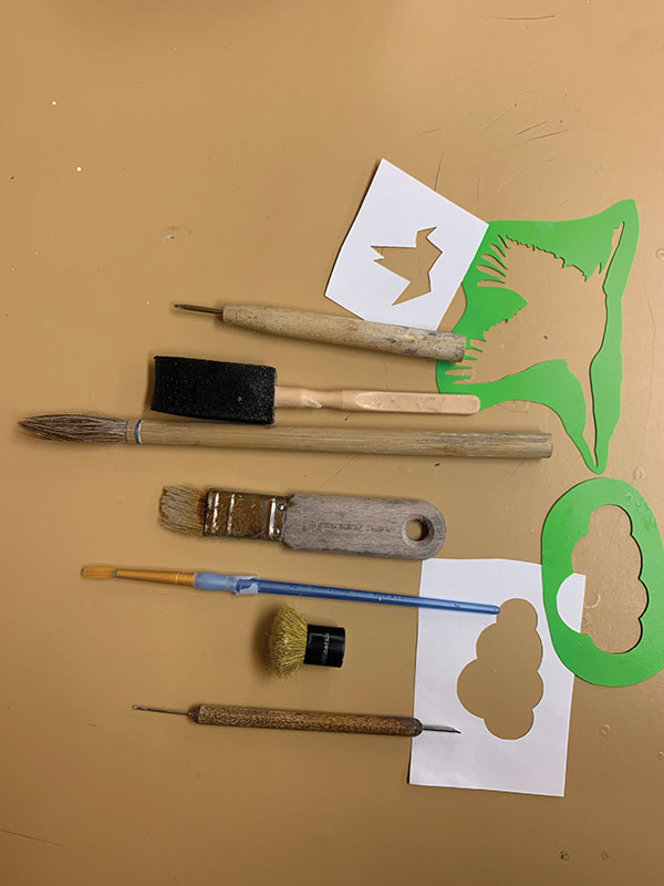 Tools: Thick and thin needle tools, make-up brush, foam brush, glaze brushes, and paper and plastic stencils.