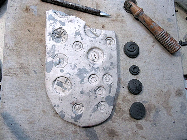 5 Make press molds of buttons or various textured objects from plaster or clay that can be used later in the work.