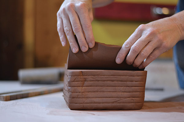 1 Create a stack of clay slabs using slab sticks and a wire tool.