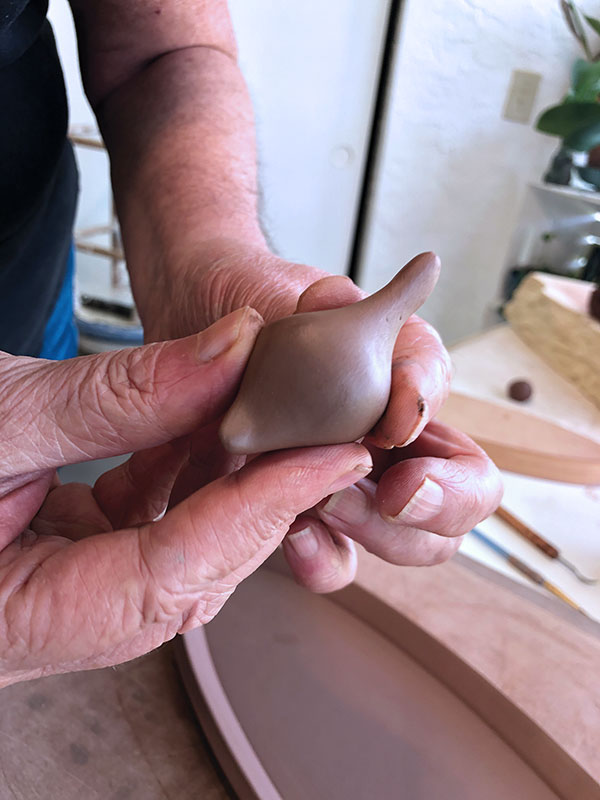 3 Form birds by making an oval and pinching one side longer for the neck.