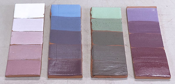 9 Color progression test tiles of Amaco underglazes (from left to right) LUG10 White, V325 Baby Blue, V345 Light Green, and V321 Lilac, each with incremental additions of powdered Amaco LG57 Intense Red glaze.