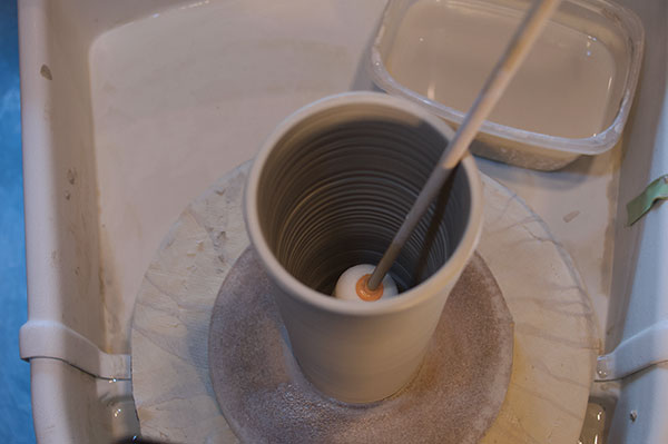 4 In use, the dowel permits reaching into tall vessels on the wheel.