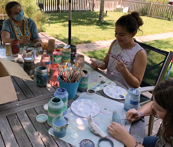 4 Caroline Douglas glazes birds with neighborhood kids. Once fired, the girls hid the birds in their Boulder neighborhood. 