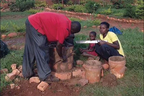 1 On-site assembly of an insulating ceramic rocket stove in Tanzania. 