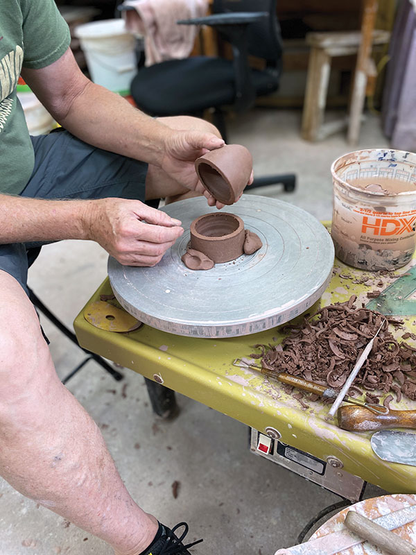 3 On the wheel, throw a small inverted bowl or cone. When leather hard, recenter it and cut to size.