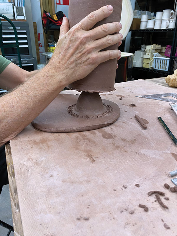 5 Attach the straight-sided cylinder onto the scored and slipped slab, centered over the small bowl.