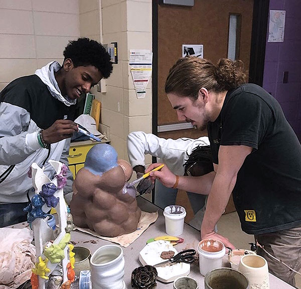 3 2019 Clay Sibling Austin Coudriet and a student finishing a sculpture on the second day of a workshop at Wellstone International High School.