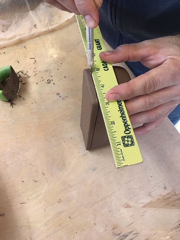 5 Using an X-Acto blade and a ruler cut a straight line at ¼ inch up all along the bottom of your box.