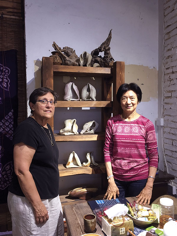 8 Marion Angelica (left) with ShiShiu Chun (right) and her ceramic pieces, 12 in. (31 cm), thrown and altered stoneware, wood fired. Photo: Ting Yueng.