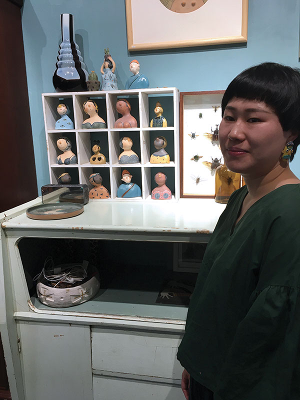 4 Junty Zhang in her studio with her figurative pieces.