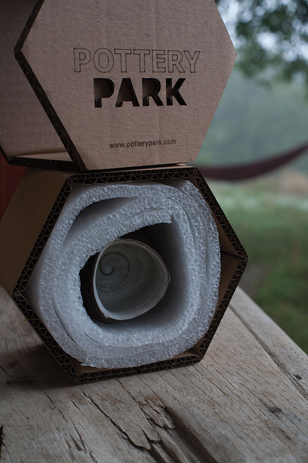 5 Interior view of a packed piece, shown securely wrapped in foam within the hexagonal box. 