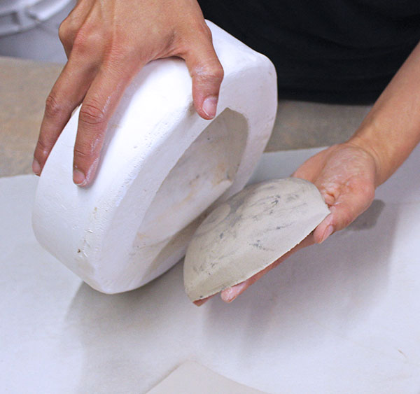 3 Flip the mold over to release the half. Set it aside to firm up to a soft leather-hard state.